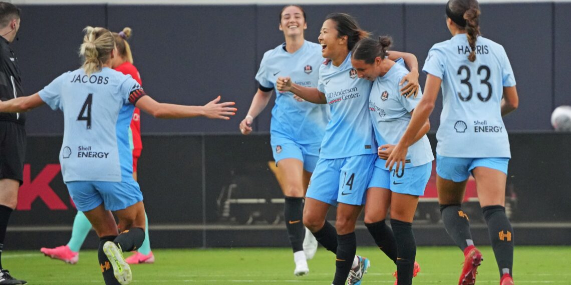 Jul 20, 2024; Kansas City, Missouri, USA; Houston Dash midfielder Yuki Nagasato (14) celebrates with teammates after scoring. Goal during the first half against the Kansas City Current at CPKC Stadium. Mandatory Credit: Denny Medley-USA TODAY Sports