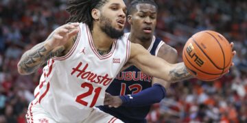 Nov 9, 2024; Houston, Texas, USA; Houston Cougars guard Emanuel Sharp (21) grabs a pass as Auburn Tigers guard Miles Kelly (13) defends during the first half at Toyota Center. Mandatory Credit: Troy Taormina-Imagn Images
