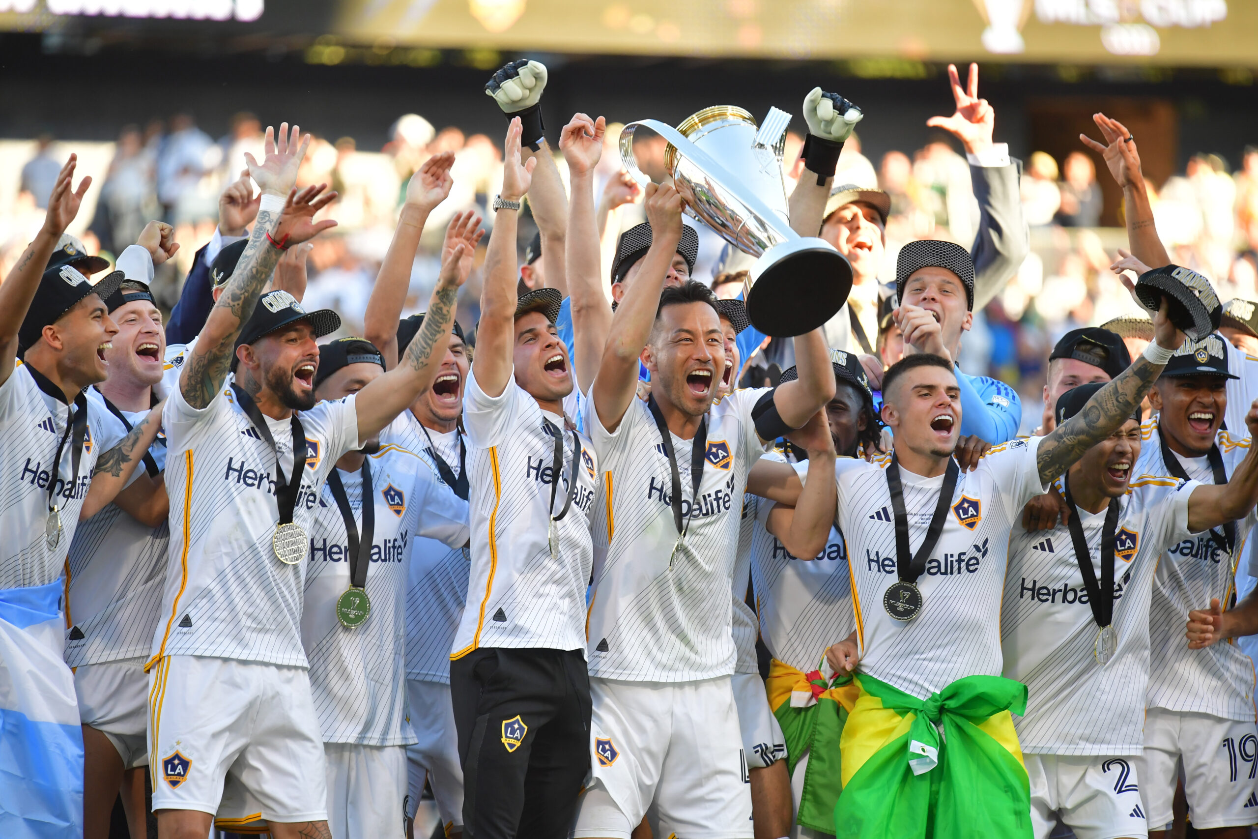 Dec 7, 2024; Carson, California, USA; LA Galaxy defender Maya Yoshida (4) celebrates with teammates and the Philip F. Anschutz trophy after defeating the New York Red Bulls in the 2024 MLS Cup at Dignity Health Sports Park. Mandatory Credit: Gary A. Vasquez-Imagn Images