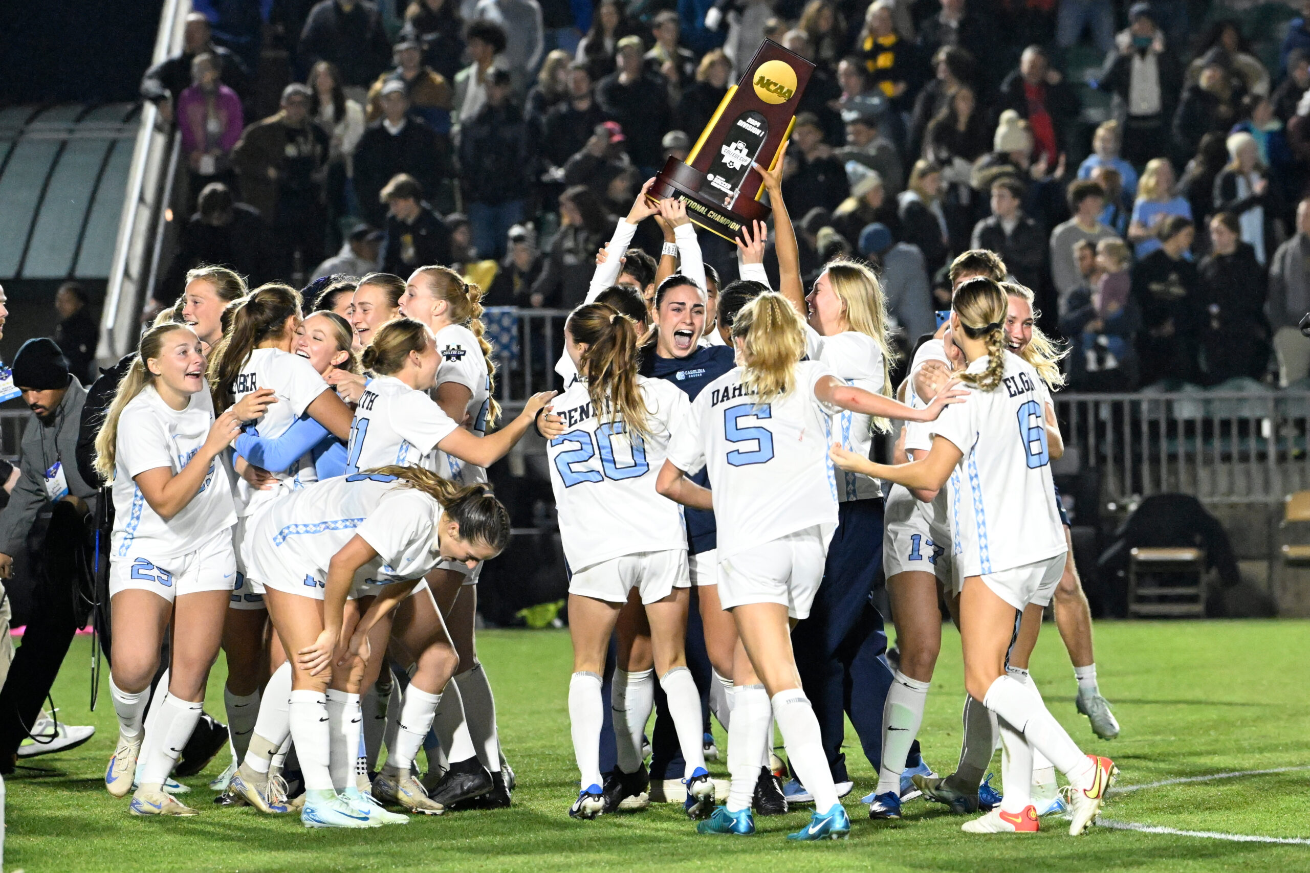 Dec 9, 2024; Cary, NC, USA; North Carolina players celebrate with the trophy after the win at WakeMed Soccer Park. Mandatory Credit: Bob Donnan-Imagn Images